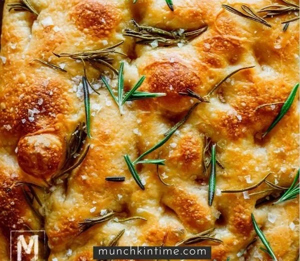 Freshly baked same day sourdough focaccia bread topped with herbs