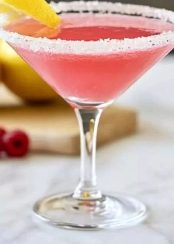 Raspberry Lemon Drop Martini garnished with a lemon slice and raspberries