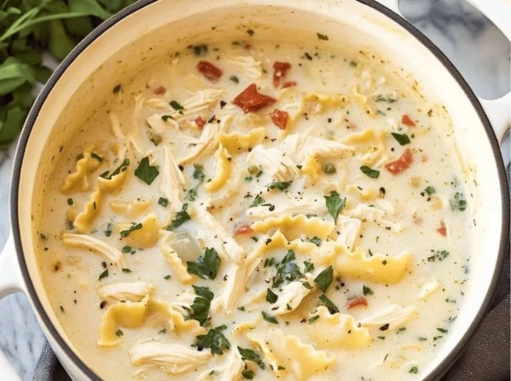 Bowl of delicious white chicken lasagna soup topped with herbs