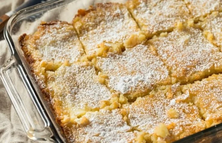 A slice of delicious Gooey Butter Cake served on a plate.