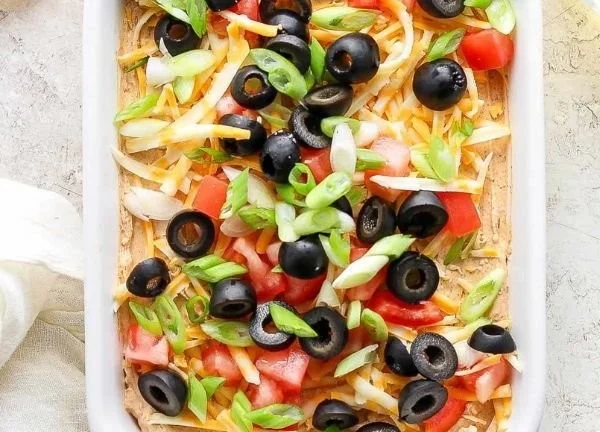 Delicious Taco Dip served in a bowl with colorful toppings
