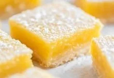 Super Easy Lemon Bars 3 Delicious super easy lemon bars on a white plate with lemon slices