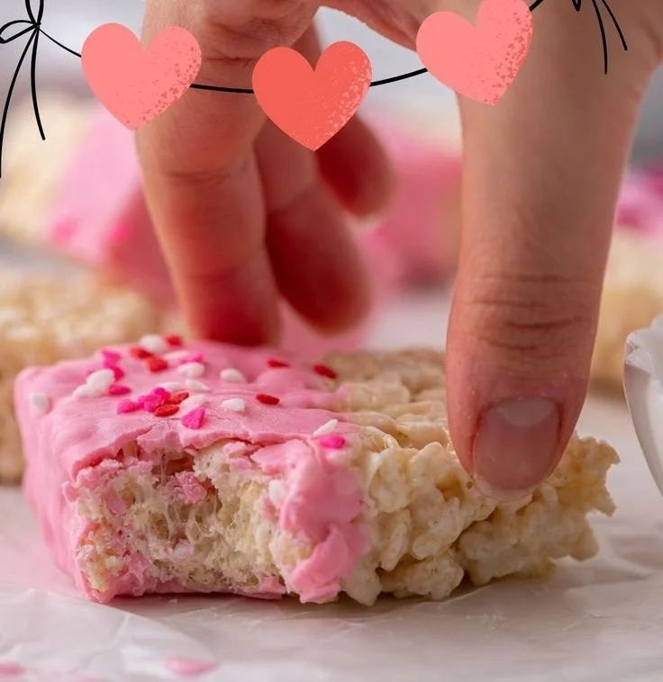 Valentine's Day chocolate-coated rice krispie treats decorated with hearts.